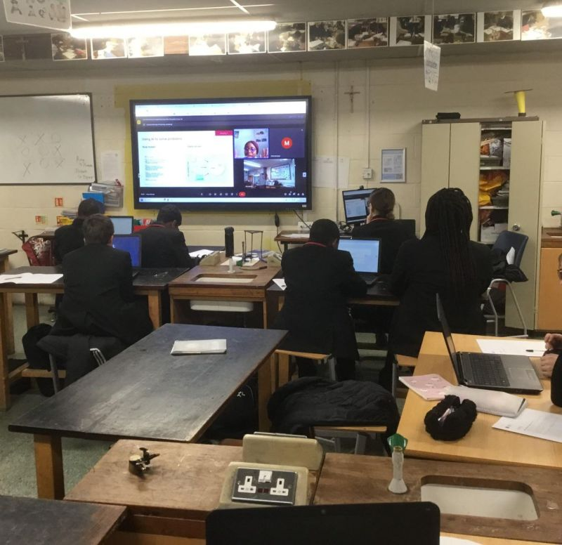 Pupils following a live remote AI session on the classroom screen